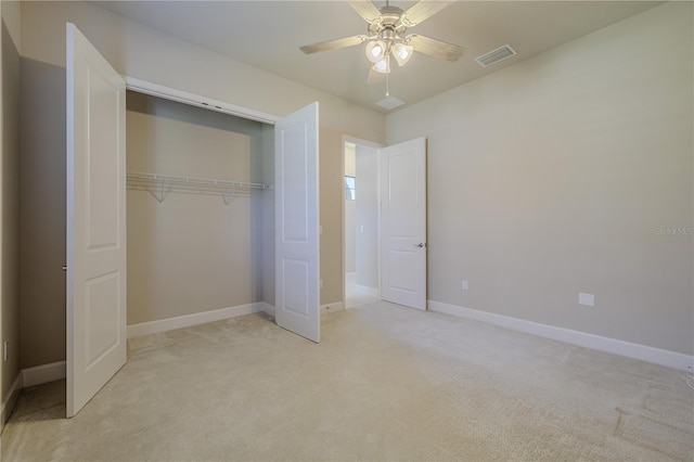 unfurnished bedroom with ceiling fan, light colored carpet, and a closet