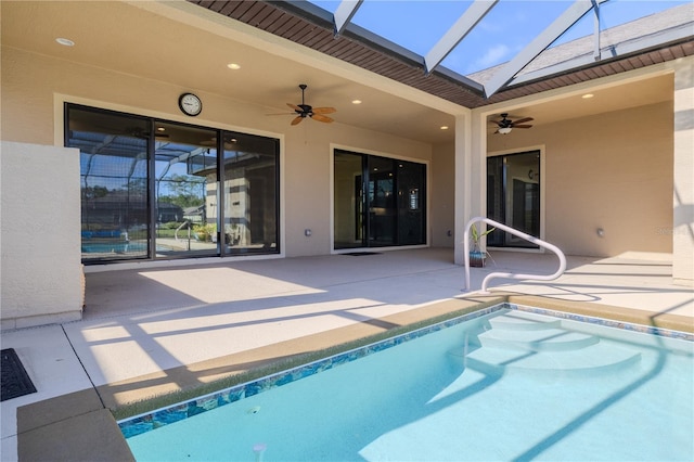 view of pool with a lanai, ceiling fan, and a patio