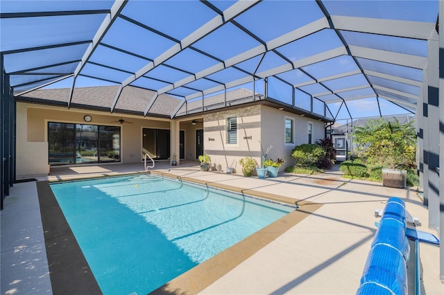 view of pool with a patio area, ceiling fan, and a lanai