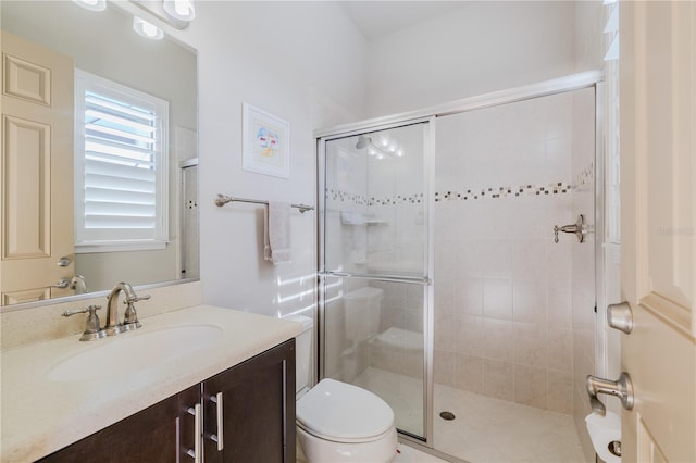 bathroom with vanity, toilet, and an enclosed shower