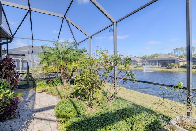 sunroom featuring a water view