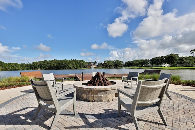 view of patio with a water view and a fire pit