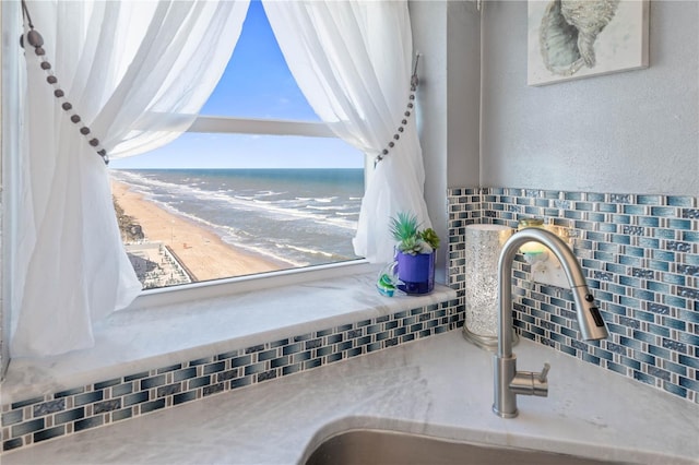 room details with a water view, sink, and a view of the beach