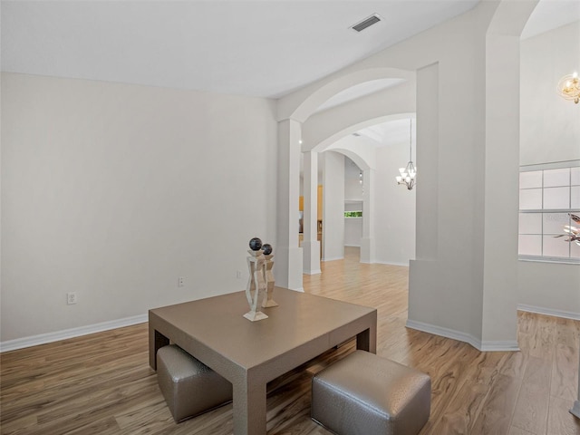 dining room featuring wood-type flooring and a chandelier