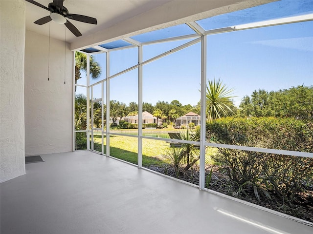 unfurnished sunroom featuring ceiling fan