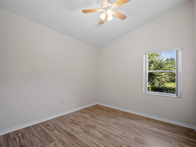 spare room with lofted ceiling, ceiling fan, and light wood-type flooring