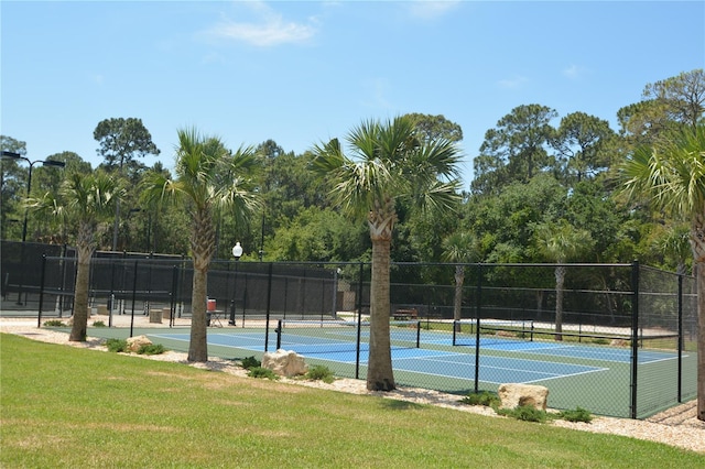 view of sport court featuring a lawn