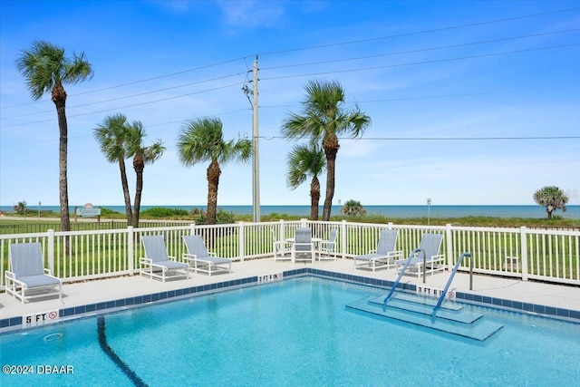 view of pool with a water view