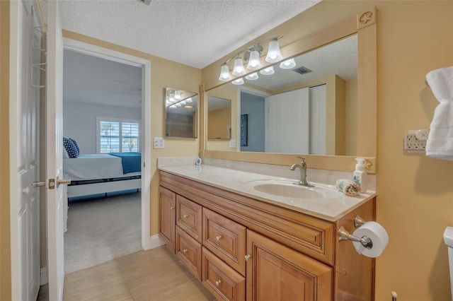 bathroom featuring vanity and a textured ceiling