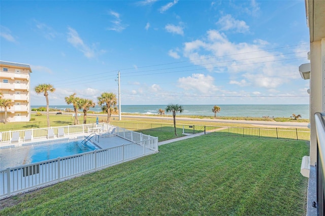 view of yard with a community pool and a water view