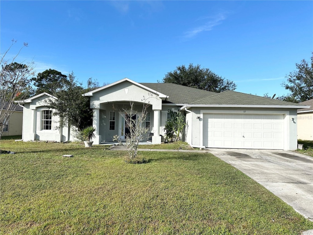 ranch-style house featuring a garage and a front lawn