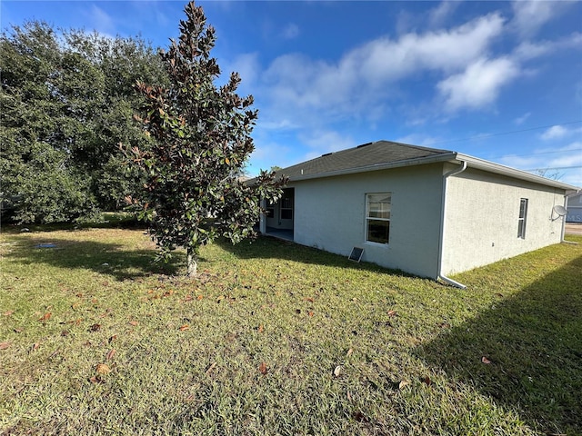 view of side of property with a lawn