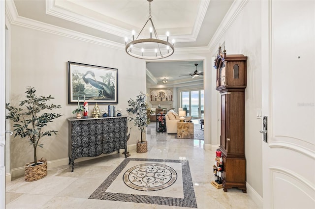 hallway featuring a chandelier, a raised ceiling, and crown molding