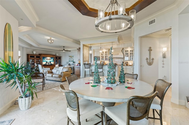 dining room with ceiling fan with notable chandelier and ornamental molding