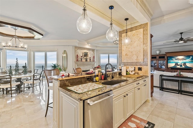 kitchen featuring light stone countertops, dishwasher, decorative light fixtures, and sink