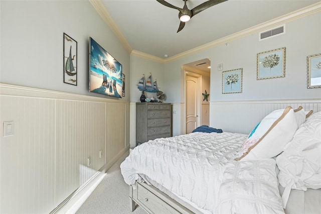 carpeted bedroom with ceiling fan and ornamental molding