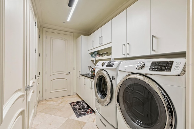 clothes washing area featuring cabinets, independent washer and dryer, and crown molding