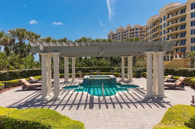 view of pool with a patio area, a pergola, and an in ground hot tub