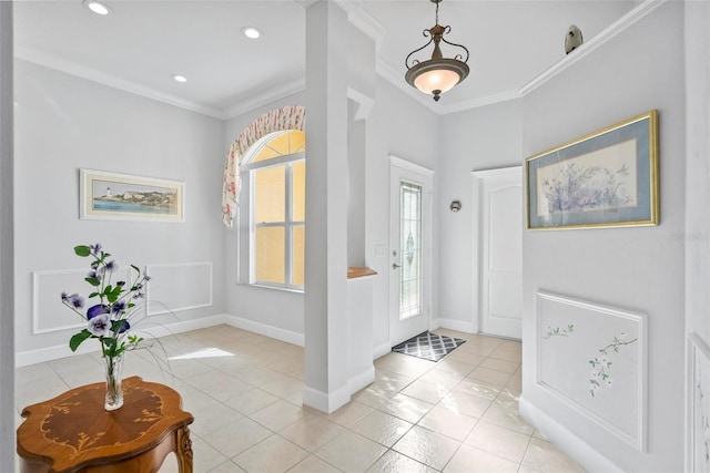 foyer entrance with crown molding and light tile patterned flooring