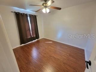 spare room featuring wood finished floors and ceiling fan