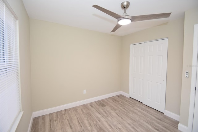 unfurnished bedroom featuring a closet, ceiling fan, and light hardwood / wood-style flooring