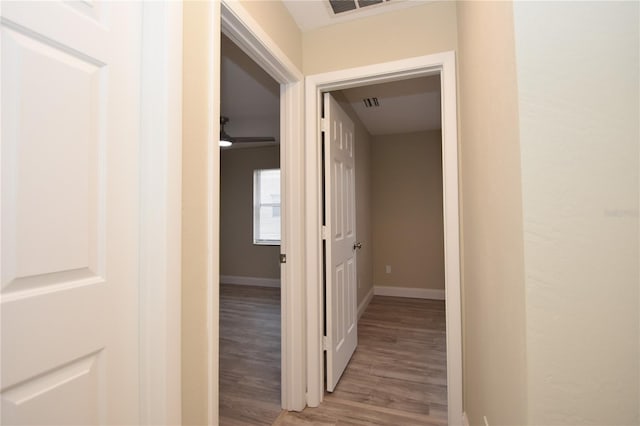 hall with hardwood / wood-style flooring