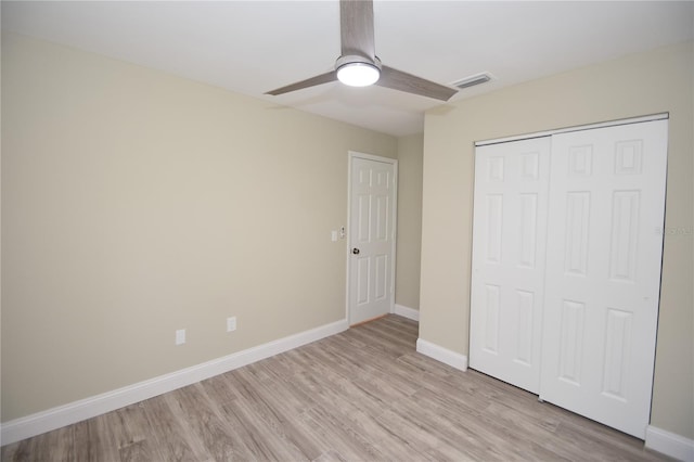 unfurnished bedroom featuring a closet, ceiling fan, and light hardwood / wood-style flooring