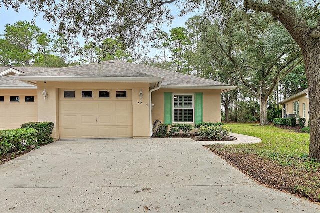 view of front of house with a front yard and a garage