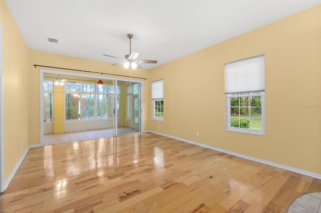 unfurnished room with light hardwood / wood-style flooring and ceiling fan