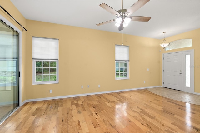 foyer entrance featuring ceiling fan, light hardwood / wood-style flooring, and a healthy amount of sunlight