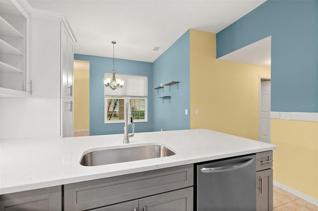 kitchen featuring stainless steel dishwasher, gray cabinetry, sink, light tile patterned floors, and a notable chandelier