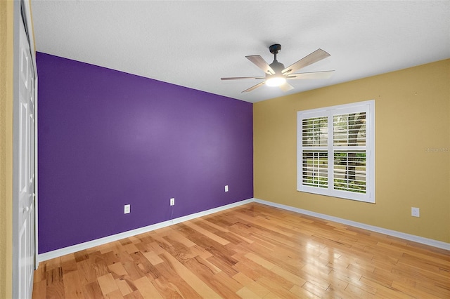 spare room with ceiling fan and light hardwood / wood-style flooring