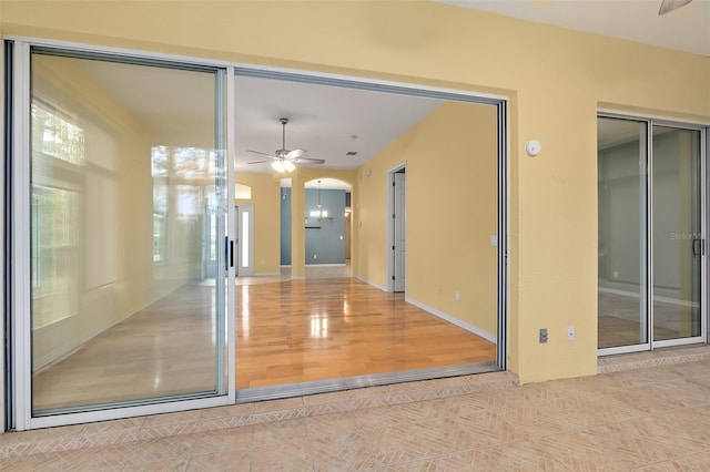 interior space with ceiling fan