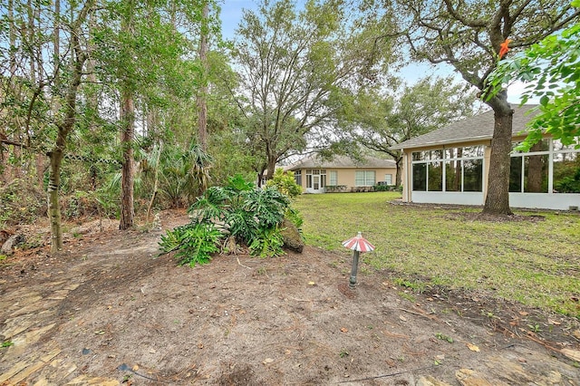 view of yard with a sunroom