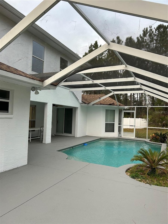 view of pool with a patio area and a lanai