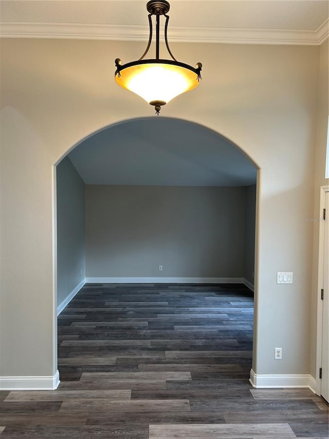 spare room with dark hardwood / wood-style flooring and ornamental molding