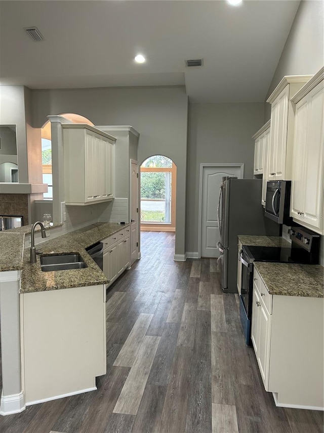 kitchen featuring kitchen peninsula, sink, white cabinetry, dark hardwood / wood-style floors, and stainless steel electric range oven