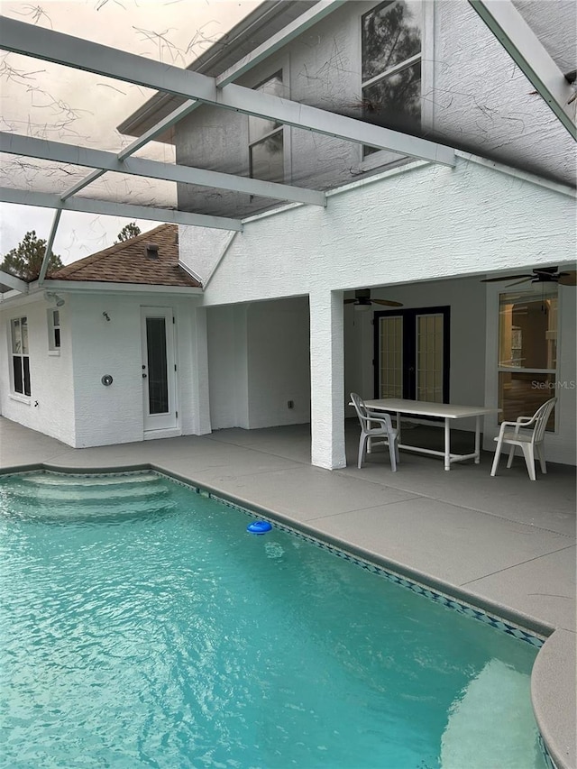 view of swimming pool with a lanai, a patio area, and ceiling fan