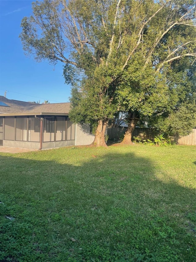 view of yard with a sunroom