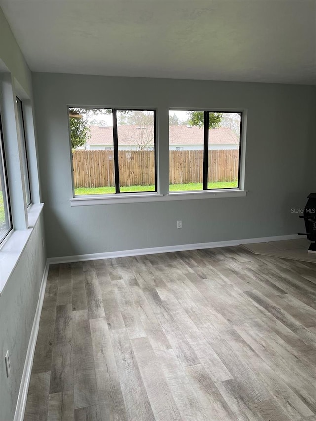 spare room with light hardwood / wood-style flooring