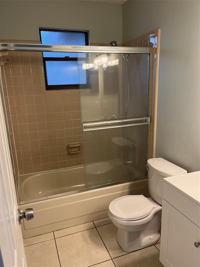 full bathroom with tile patterned flooring, vanity, toilet, and shower / bath combination with glass door