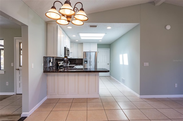 kitchen with pendant lighting, white cabinetry, light tile patterned floors, kitchen peninsula, and stainless steel appliances