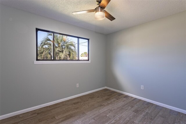 unfurnished room with a textured ceiling, wood-type flooring, and ceiling fan