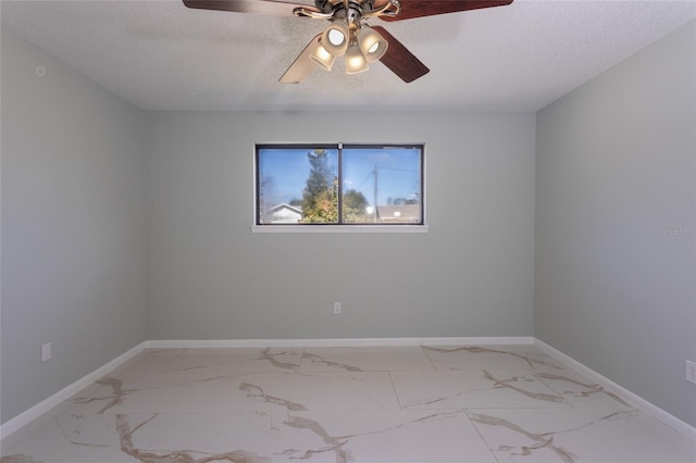 empty room featuring ceiling fan and a textured ceiling