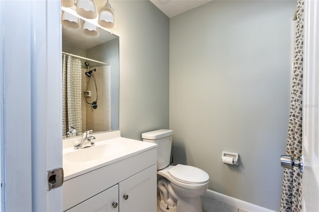 bathroom featuring vanity, curtained shower, and toilet