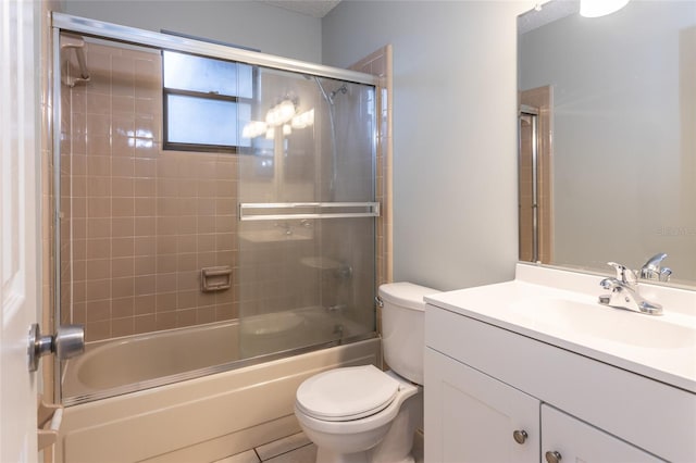 full bathroom featuring enclosed tub / shower combo, vanity, and toilet