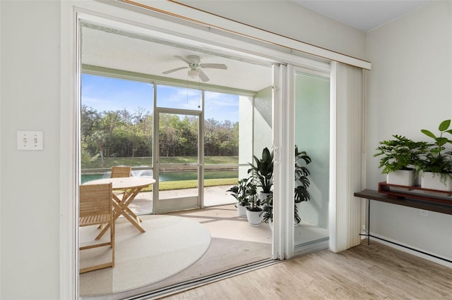 doorway to outside with light hardwood / wood-style flooring and ceiling fan