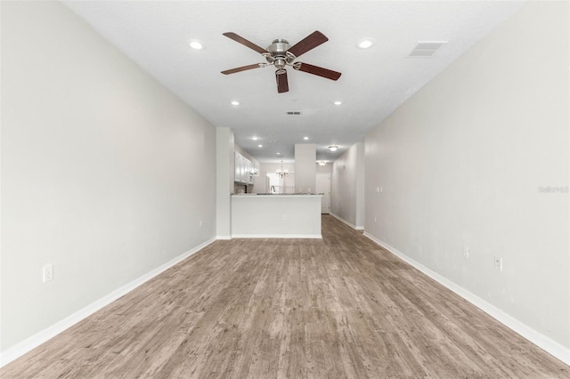 unfurnished living room featuring light hardwood / wood-style flooring and ceiling fan