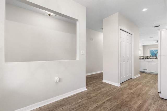 hallway with hardwood / wood-style floors