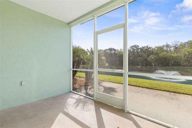 unfurnished sunroom with a water view